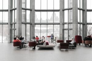 Spacious lounge with modern decor and large windows showcasing a snowy Ottawa view.